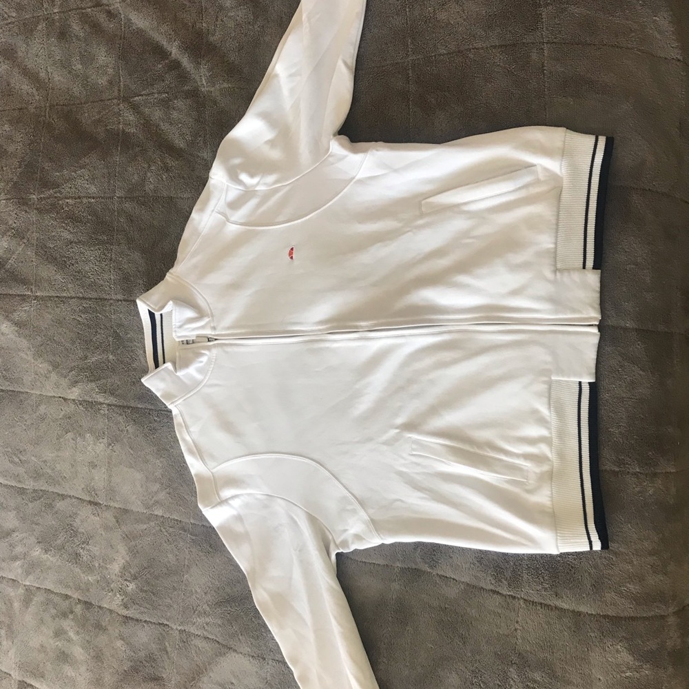 White zip up Ellesse sweater with stand up collar.